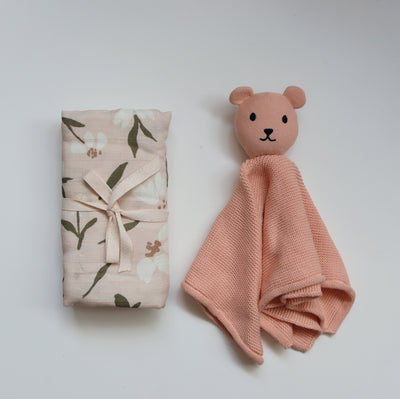 Peach baby gift box with floral muslin swaddle and knitted comforter